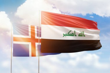 Sunny blue sky and flags of iraq and iceland
