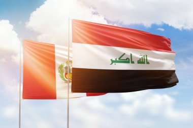 Sunny blue sky and flags of iraq and peru