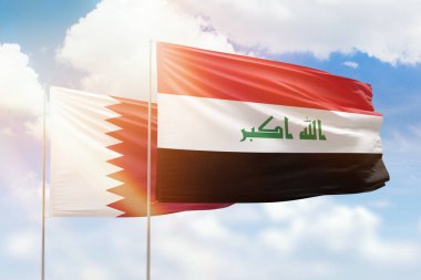 Sunny blue sky and flags of iraq and qatar