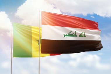 Sunny blue sky and flags of iraq and senegal