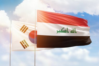 Sunny blue sky and flags of iraq and south korea