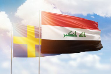 Sunny blue sky and flags of iraq and sweden
