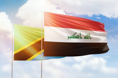 Sunny blue sky and flags of iraq and tanzania