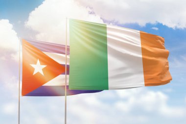 Sunny blue sky and flags of ireland and cuba