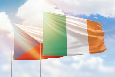 Sunny blue sky and flags of ireland and czechia