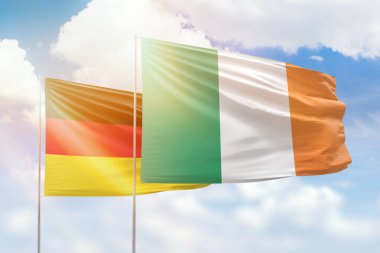 Sunny blue sky and flags of ireland and germany
