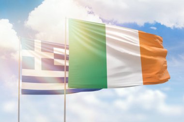 Sunny blue sky and flags of ireland and greece