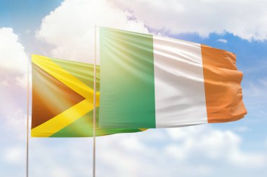 Sunny blue sky and flags of ireland and jamaica