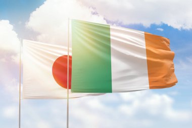 Sunny blue sky and flags of ireland and japan