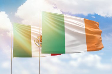 Sunny blue sky and flags of ireland and mexico