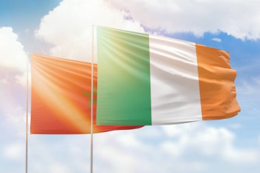 Sunny blue sky and flags of ireland and morocco