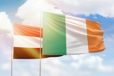 Sunny blue sky and flags of ireland and yemen