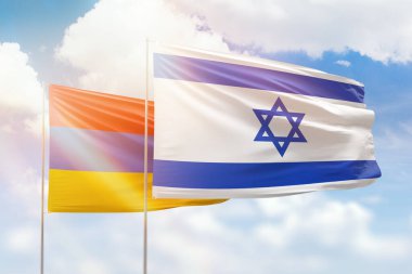 Sunny blue sky and flags of israel and armenia