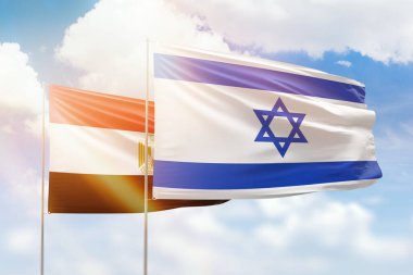 Sunny blue sky and flags of israel and egypt
