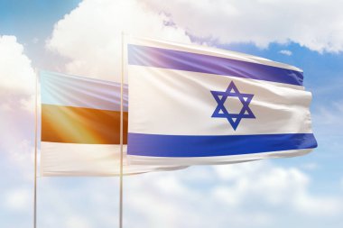 Sunny blue sky and flags of israel and estonia