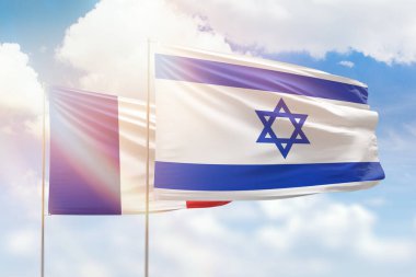 Sunny blue sky and flags of israel and france