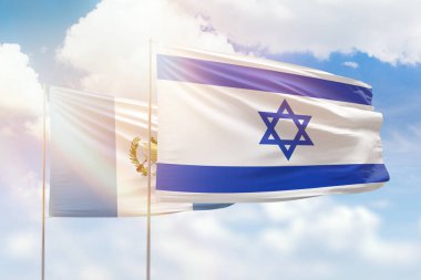 Sunny blue sky and flags of israel and guatemala
