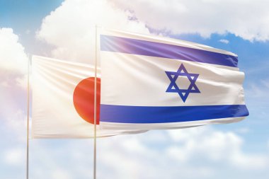 Sunny blue sky and flags of israel and japan