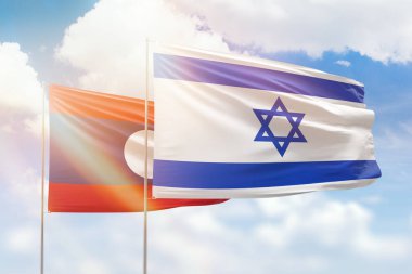 Sunny blue sky and flags of israel and laos