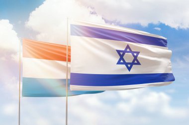 Sunny blue sky and flags of israel and luxembourg