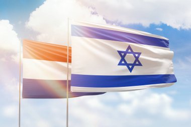 Sunny blue sky and flags of israel and netherlands