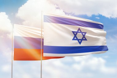 Sunny blue sky and flags of israel and russia