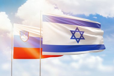 Sunny blue sky and flags of israel and slovenia