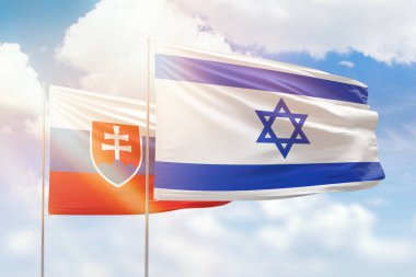 Sunny blue sky and flags of israel and slovakia