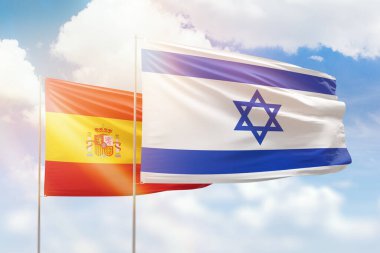 Sunny blue sky and flags of israel and spain