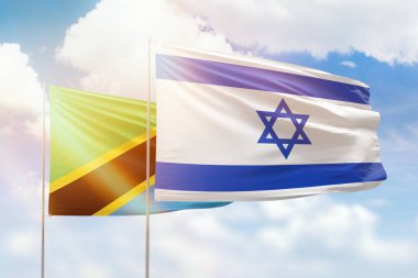 Sunny blue sky and flags of israel and tanzania