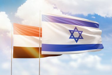 Sunny blue sky and flags of israel and yemen