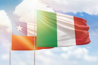Sunny blue sky and flags of italy and chile