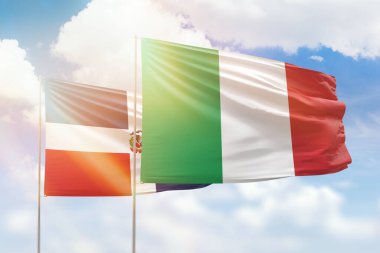 Sunny blue sky and flags of italy and dominican republic