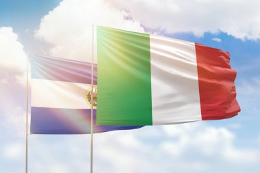Sunny blue sky and flags of italy and el salvador