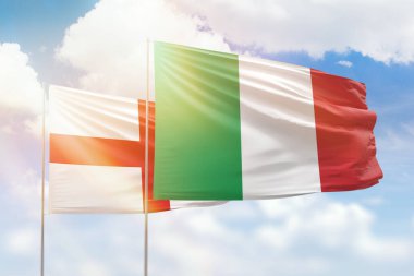Sunny blue sky and flags of italy and england