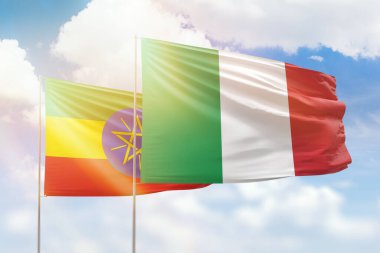 Sunny blue sky and flags of italy and ethiopia