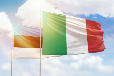 Sunny blue sky and flags of italy and estonia