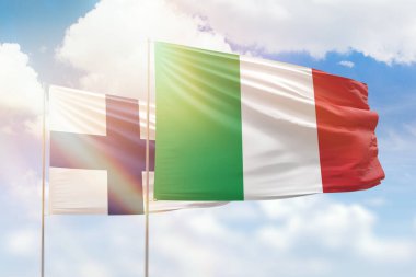 Sunny blue sky and flags of italy and finland