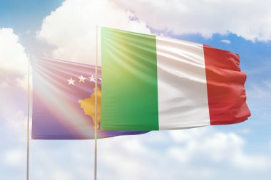 Sunny blue sky and flags of italy and kosovo