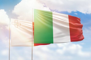 Sunny blue sky and flags of italy and malta
