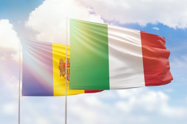 Sunny blue sky and flags of italy and moldova
