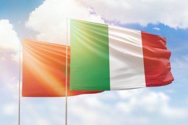 Sunny blue sky and flags of italy and morocco