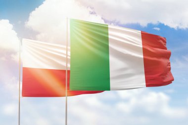 Sunny blue sky and flags of italy and poland
