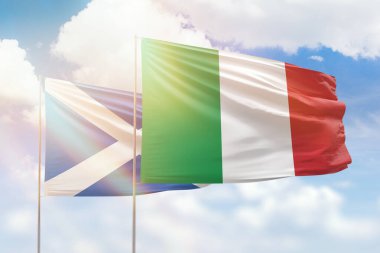 Sunny blue sky and flags of italy and scotland