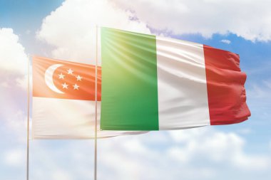 Sunny blue sky and flags of italy and singapore