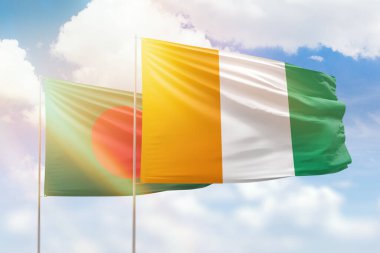 Sunny blue sky and flags of ivory coast and bangladesh