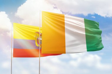 Sunny blue sky and flags of ivory coast and ecuador