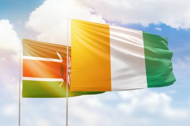 Sunny blue sky and flags of ivory coast and kenya