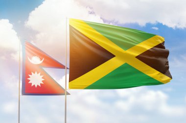 Sunny blue sky and flags of jamaica and nepal