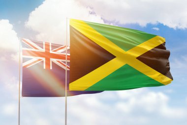 Sunny blue sky and flags of jamaica and new zealand